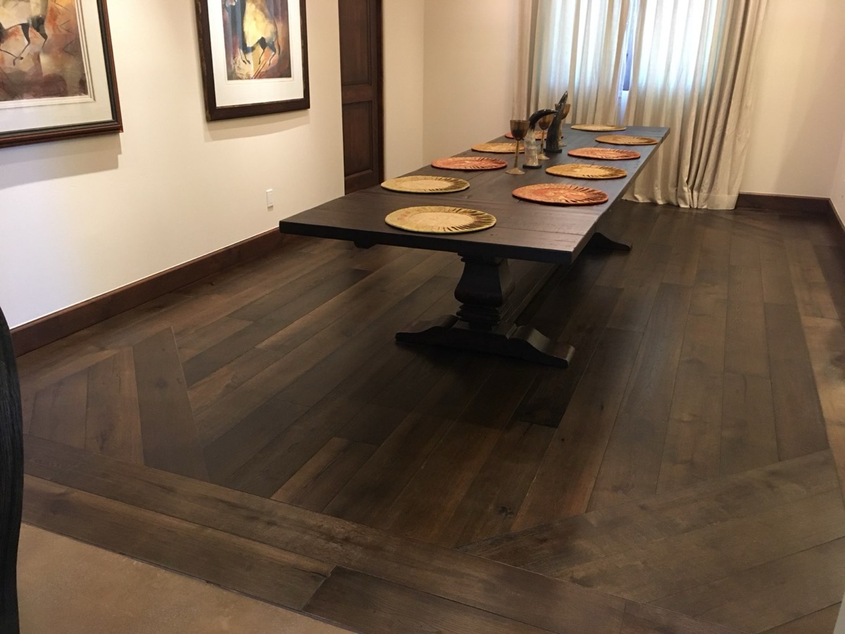 Refinished dark dining room floor with a custom border inlay