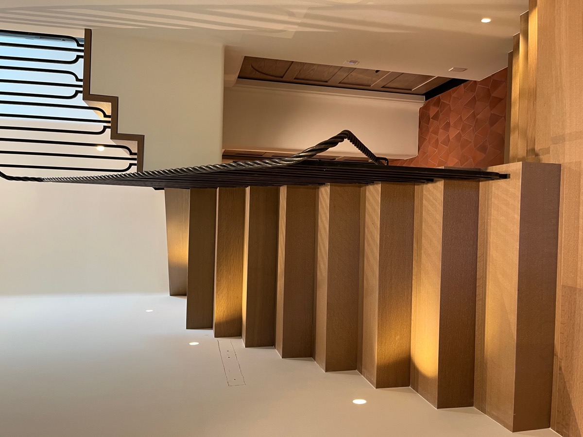 Oak staircase with wrought-iron railing and step lighting